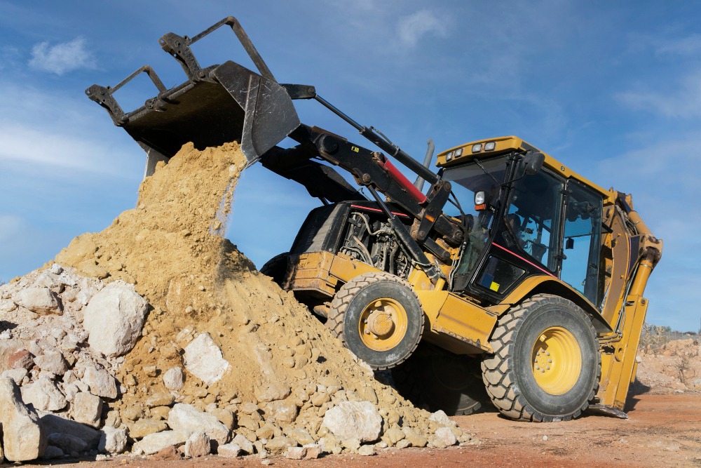 truck offloading sand and stones dirt